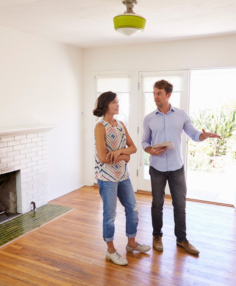 demo-attachment-41-male-realtor-showing-female-client-around-house-PXLCYLL-784x951