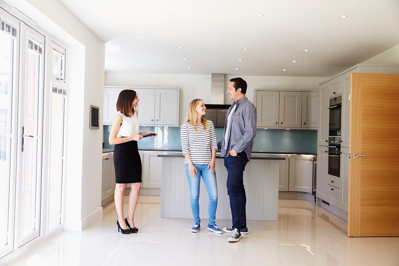demo-attachment-103-realtor-showing-young-couple-around-property-for-PDHK2DX